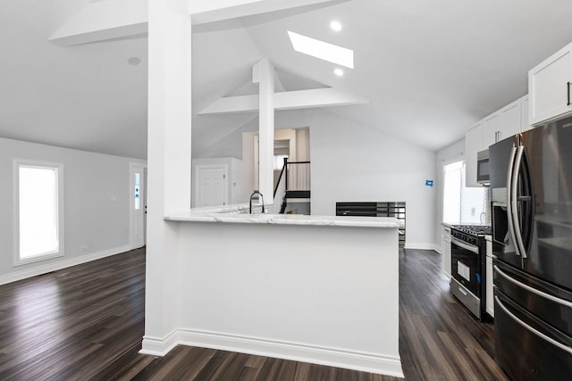 kitchen featuring kitchen peninsula, white cabinets, dark wood-type flooring, and appliances with stainless steel finishes