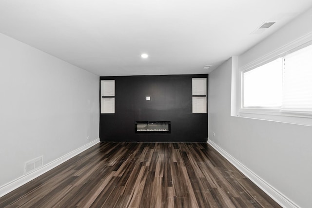 spare room with dark hardwood / wood-style flooring