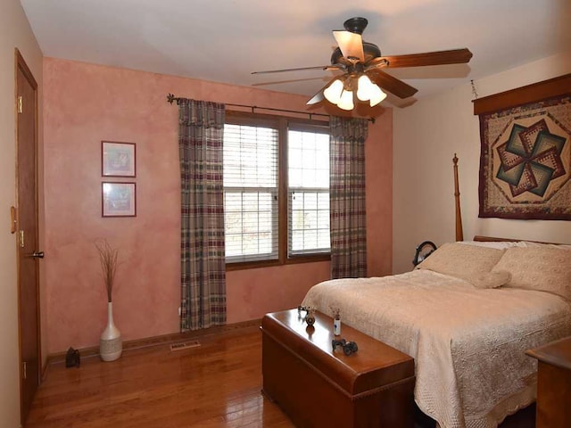 bedroom featuring hardwood / wood-style floors and ceiling fan