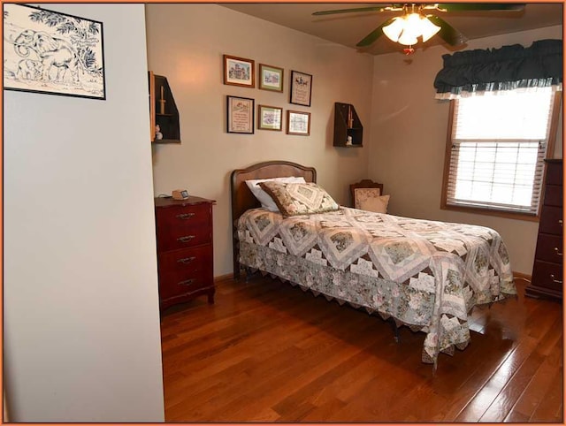 bedroom with ceiling fan and dark hardwood / wood-style flooring