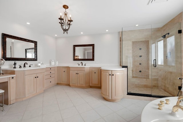 bathroom featuring an inviting chandelier, shower with separate bathtub, tile patterned floors, and vanity