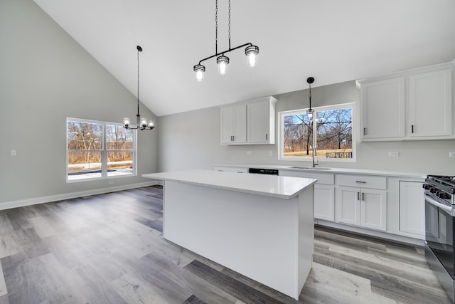 kitchen with a chandelier, a center island, white cabinetry, and black range with gas cooktop