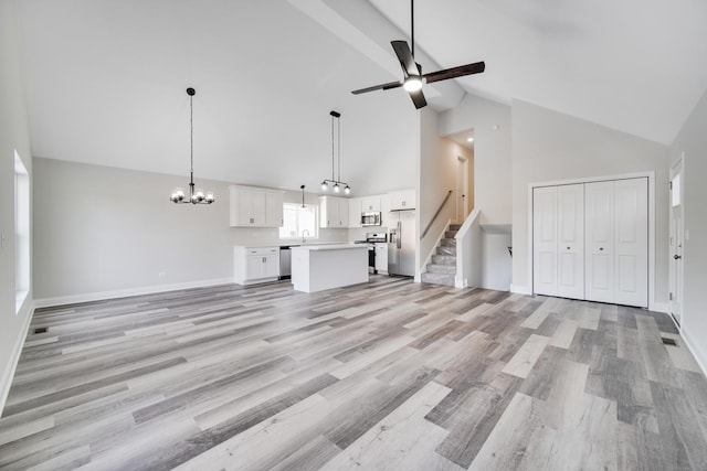 unfurnished living room featuring high vaulted ceiling, ceiling fan with notable chandelier, sink, light hardwood / wood-style flooring, and beam ceiling