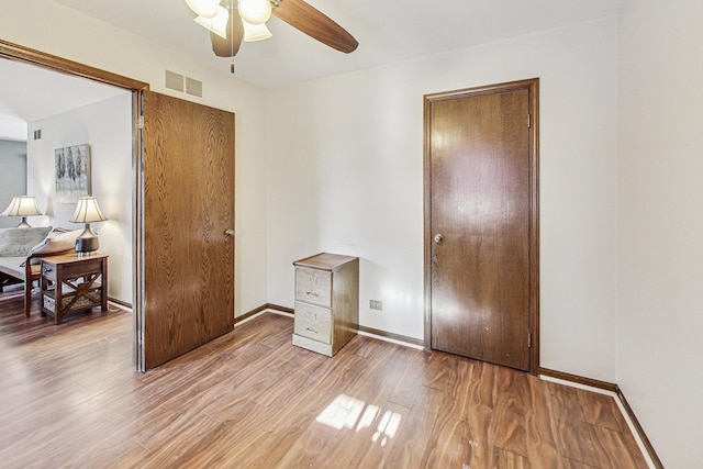 bedroom with ceiling fan and light wood-type flooring