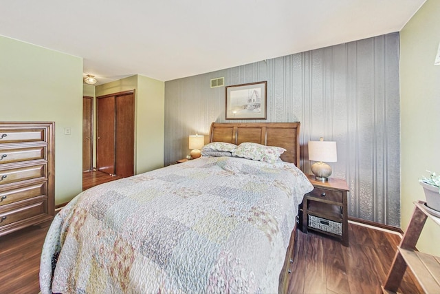 bedroom featuring dark hardwood / wood-style floors and a closet