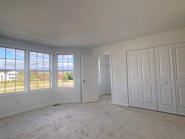 unfurnished bedroom featuring light colored carpet