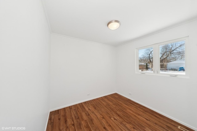 unfurnished room featuring hardwood / wood-style flooring and crown molding