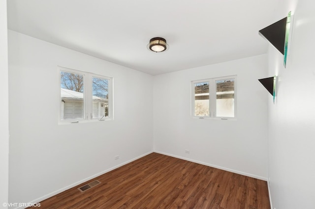 spare room with dark hardwood / wood-style floors