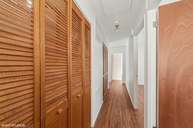 hallway with hardwood / wood-style floors