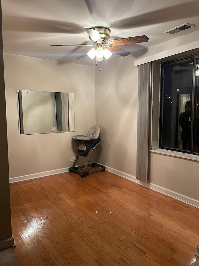 unfurnished room featuring ceiling fan and wood-type flooring