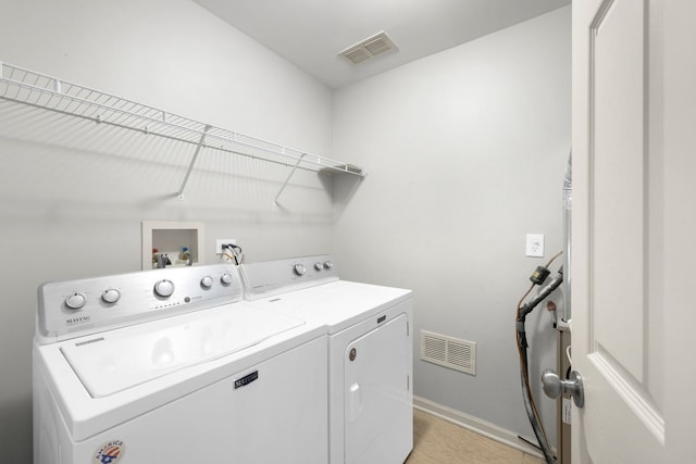 laundry area with washing machine and clothes dryer