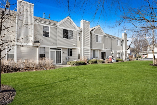 rear view of house with a lawn