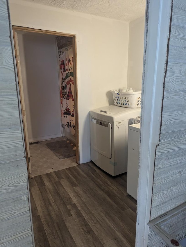 laundry room featuring dark hardwood / wood-style flooring, a textured ceiling, and independent washer and dryer