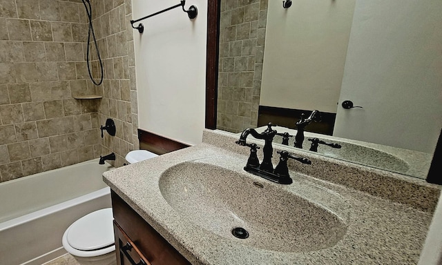 full bathroom featuring vanity, toilet, and tiled shower / bath