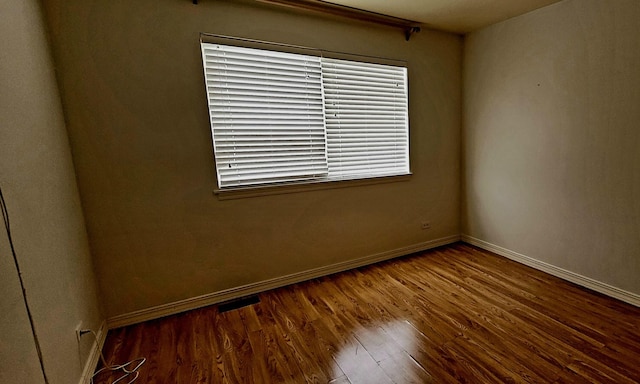 unfurnished room featuring hardwood / wood-style flooring