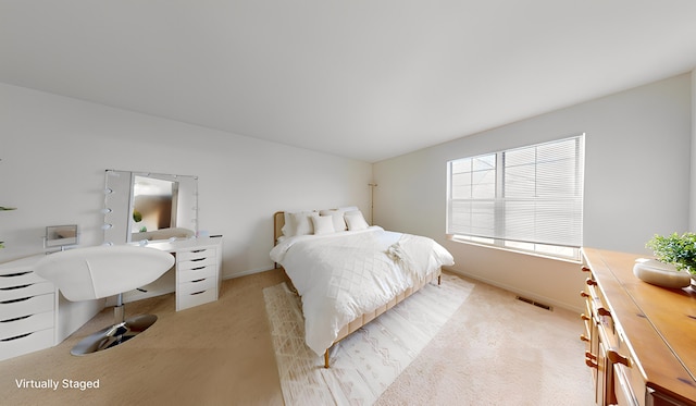 bedroom featuring light carpet