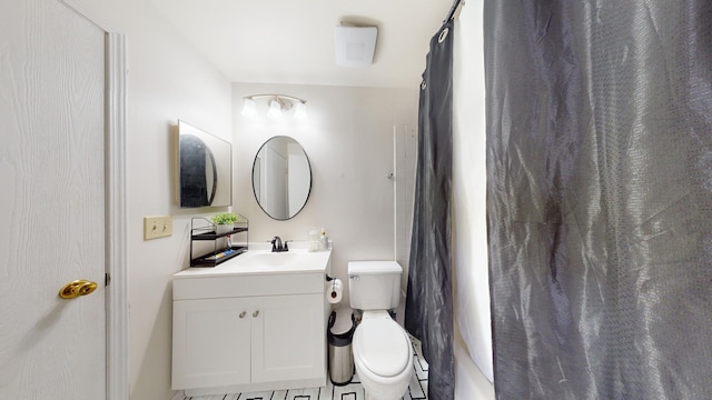 bathroom featuring vanity, toilet, and walk in shower