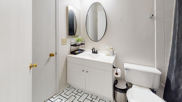 bathroom featuring tile patterned flooring, vanity, and toilet