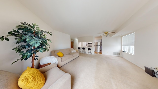 carpeted living room featuring ceiling fan