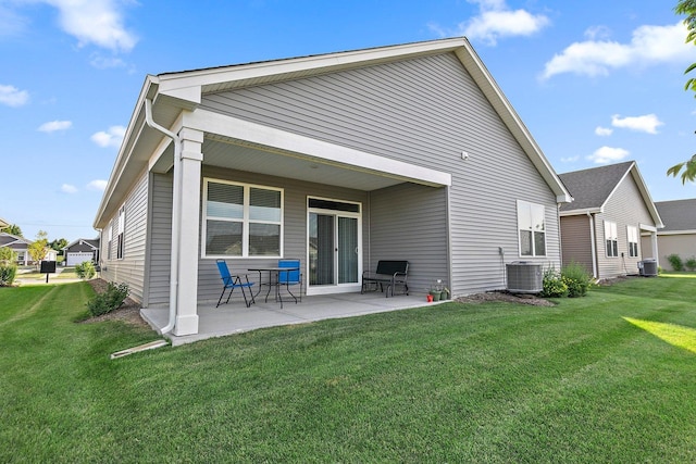 rear view of property featuring central AC, a yard, and a patio