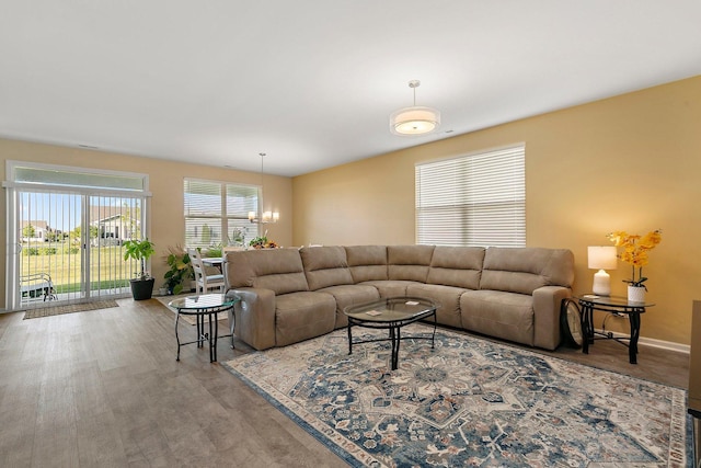 living room featuring light hardwood / wood-style floors and a chandelier