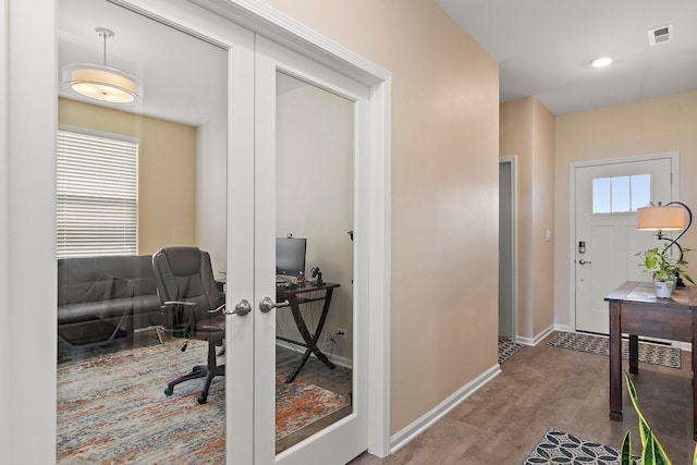 office space with hardwood / wood-style flooring and french doors