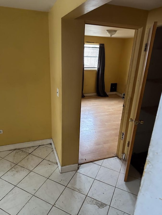 corridor with light tile patterned flooring