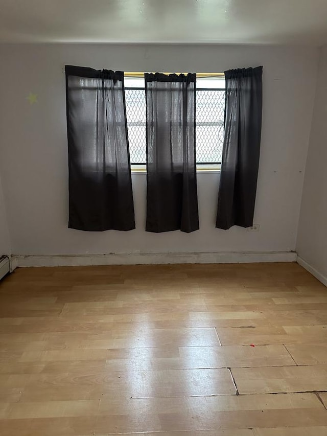 unfurnished room featuring light hardwood / wood-style floors