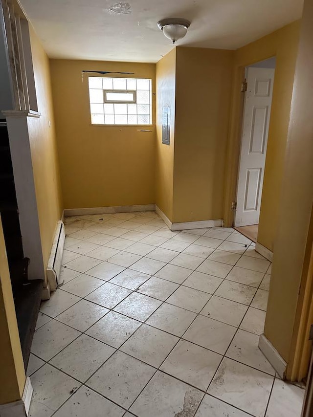 spare room featuring a baseboard heating unit