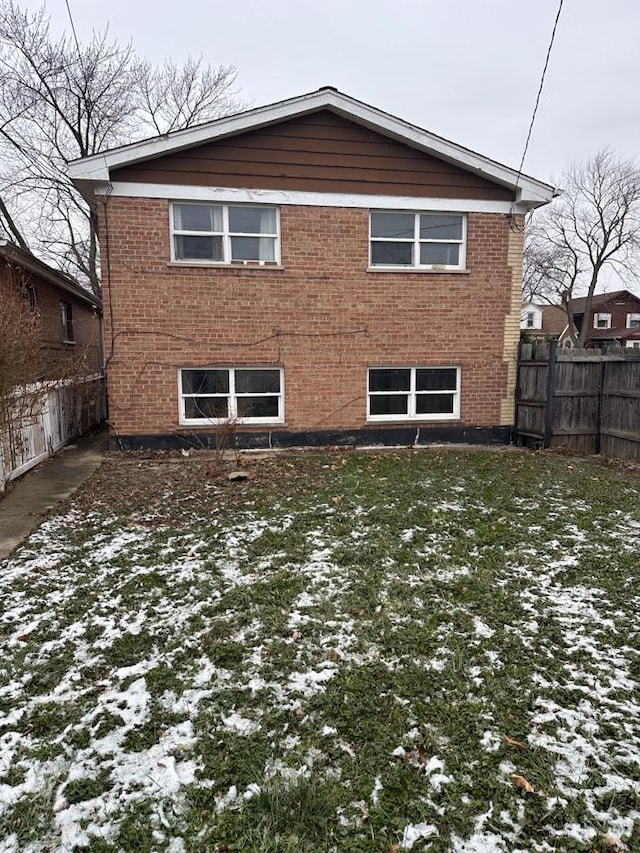 snow covered property with a lawn