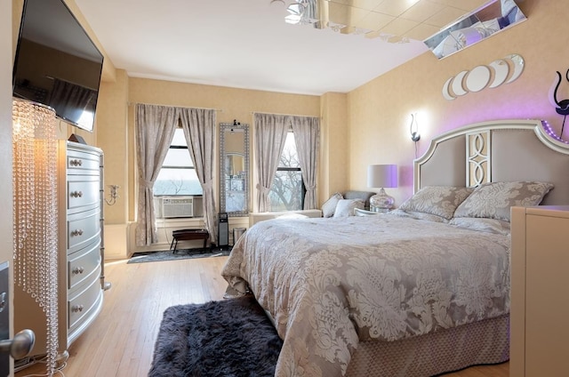 bedroom featuring cooling unit and light hardwood / wood-style flooring