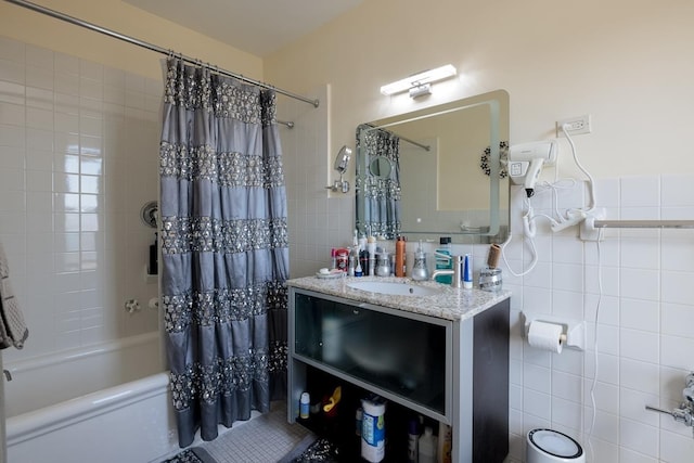 bathroom featuring vanity, tile walls, and shower / bathtub combination with curtain