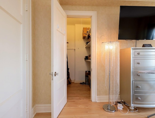 hallway with light hardwood / wood-style floors