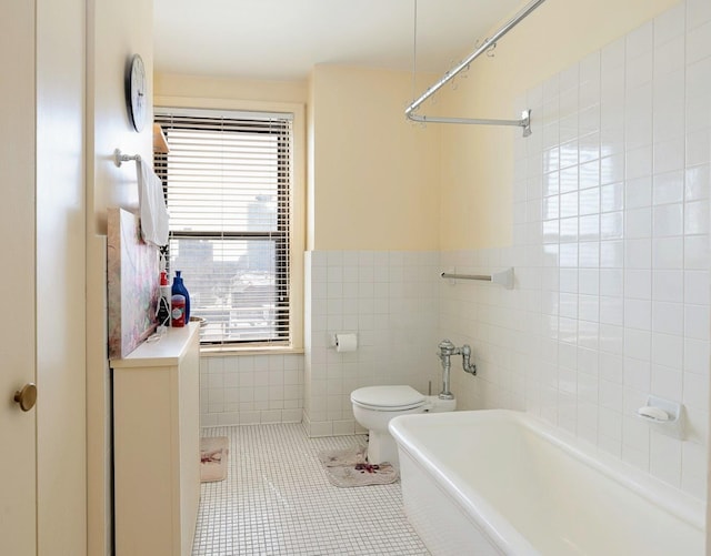 bathroom featuring tile walls, toilet, and tile patterned flooring