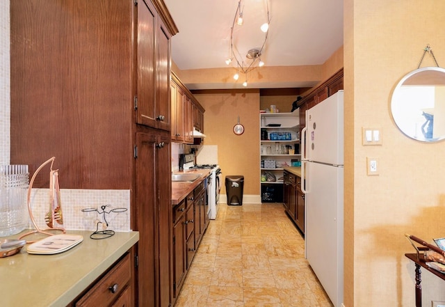 kitchen with backsplash and white appliances