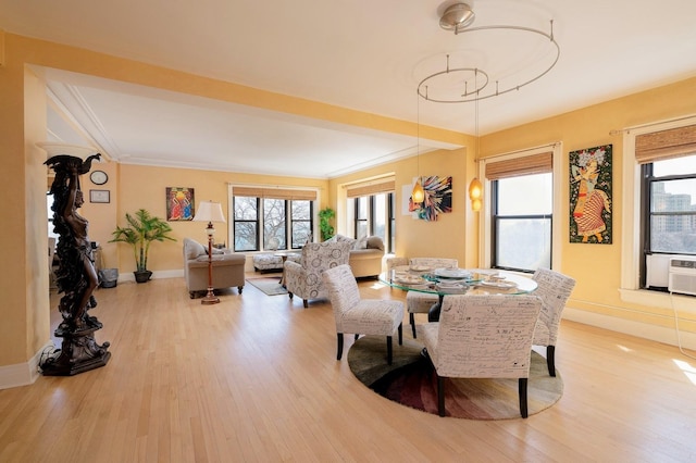 dining room with hardwood / wood-style flooring and ornamental molding