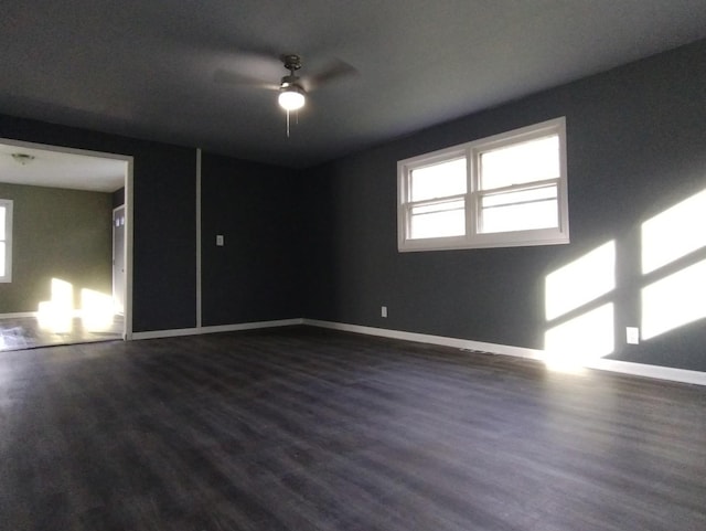 unfurnished room with dark hardwood / wood-style flooring and ceiling fan