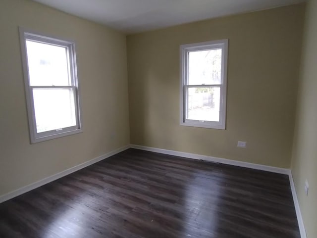 unfurnished room featuring dark wood-type flooring