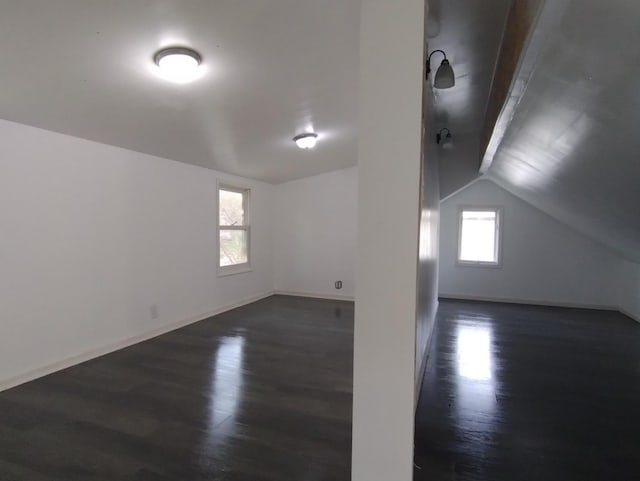 bonus room with dark hardwood / wood-style flooring and lofted ceiling