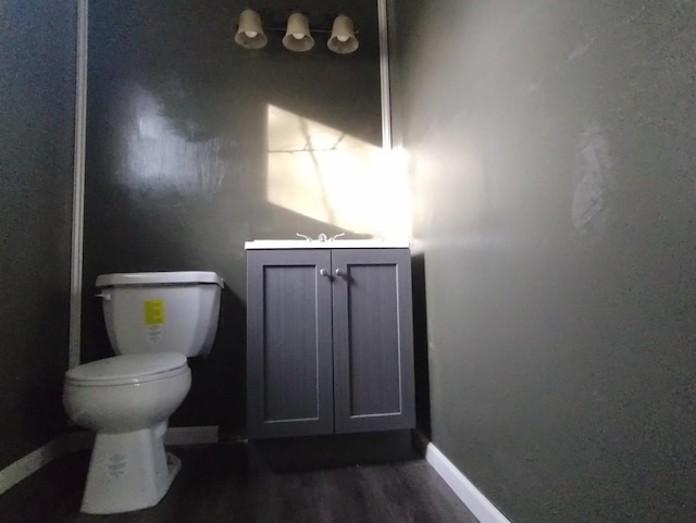 bathroom featuring hardwood / wood-style floors, vanity, and toilet