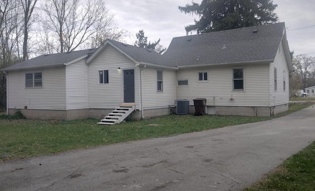 back of property featuring a yard and cooling unit