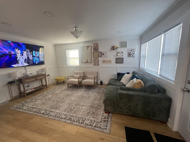 living room featuring crown molding and wood-type flooring