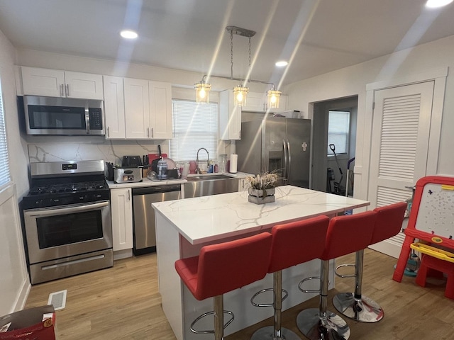 16529 Green St, Harvey, IL 60426 - kitchen with appliances with stainless steel finishes, a sink, white cabinets, plenty of natural light, and recessed lighting