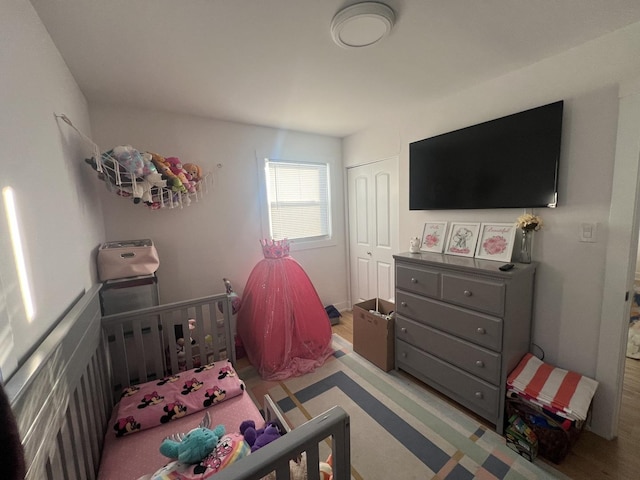 bedroom featuring light wood-type flooring and a closet