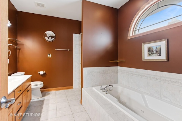 bathroom with toilet, tile patterned flooring, vanity, and a relaxing tiled tub