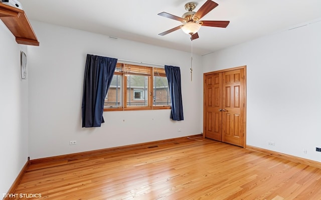 empty room featuring ceiling fan and light wood-type flooring