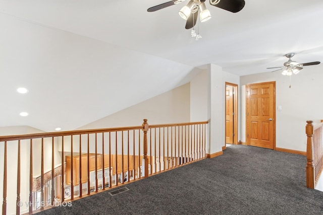 hall featuring lofted ceiling and carpet