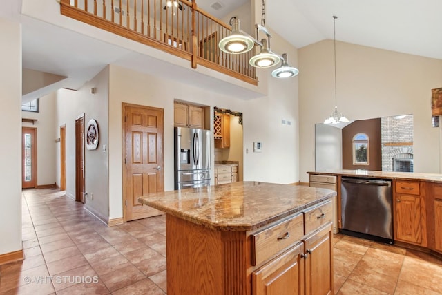 kitchen featuring dishwasher, high vaulted ceiling, hanging light fixtures, stainless steel fridge, and a kitchen island