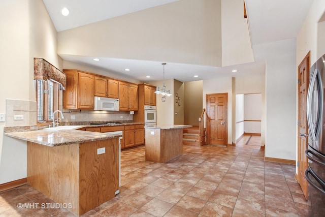 kitchen featuring white appliances, sink, high vaulted ceiling, and kitchen peninsula