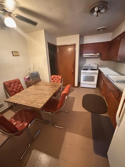 kitchen featuring gas range gas stove, sink, and extractor fan